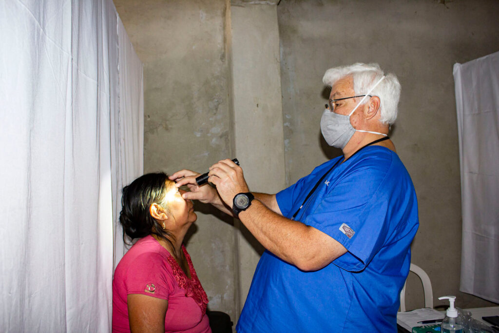 Ministry doctor examining an adult.