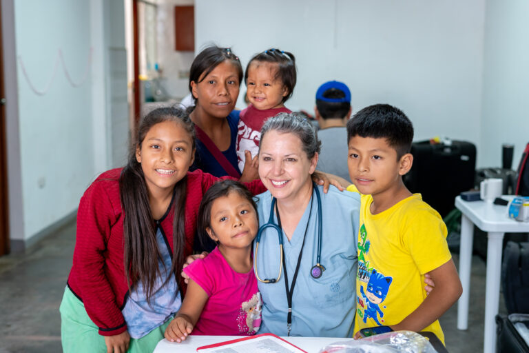Dr Harrod with a family in Ventanilla